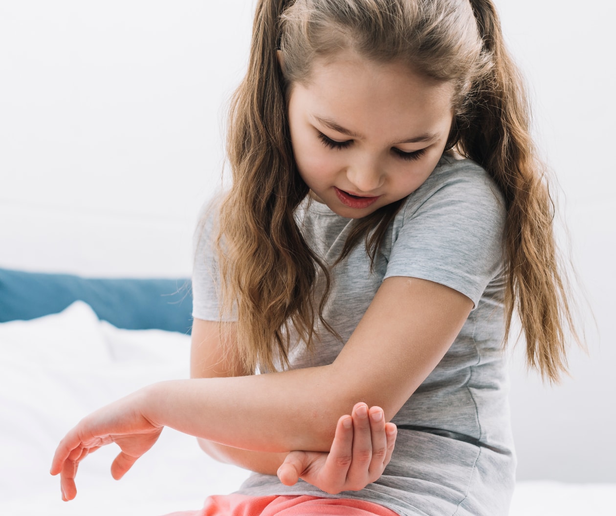 Image of a child holding her injured hand